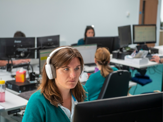 Two members of the Naked Solar customer experience team at their desks